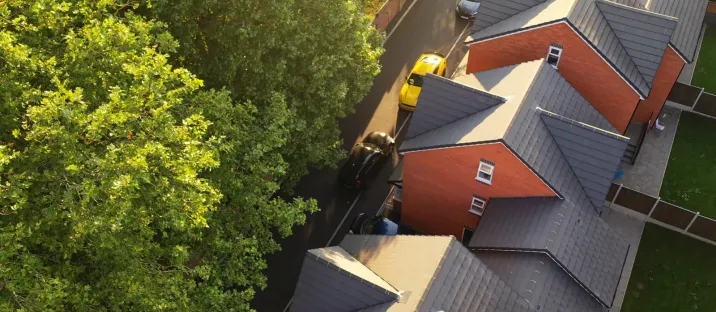 Aerial view of a row of completed pitched roofs on a residential complex